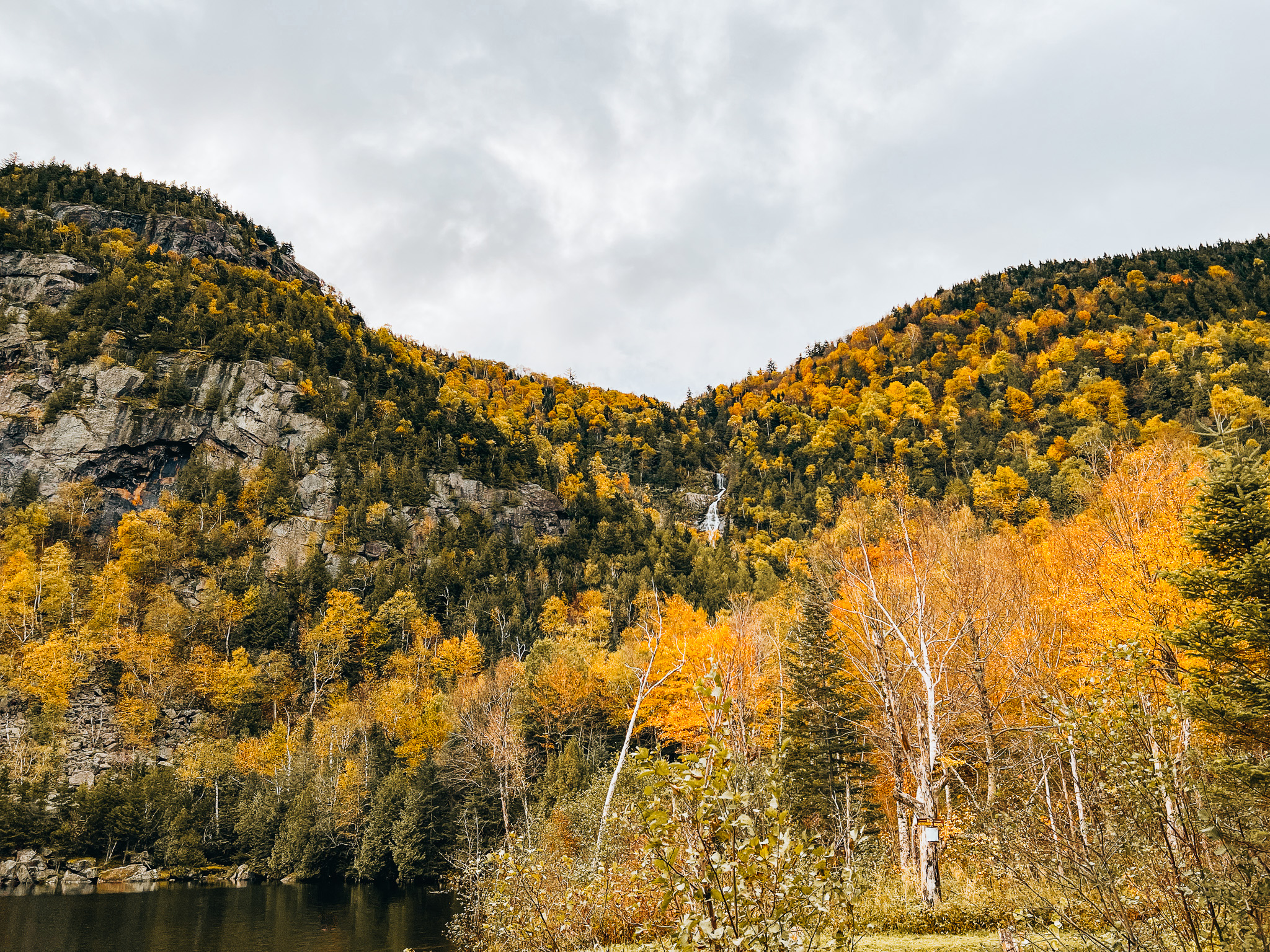 Cascade Lake waterfall among fall foliage