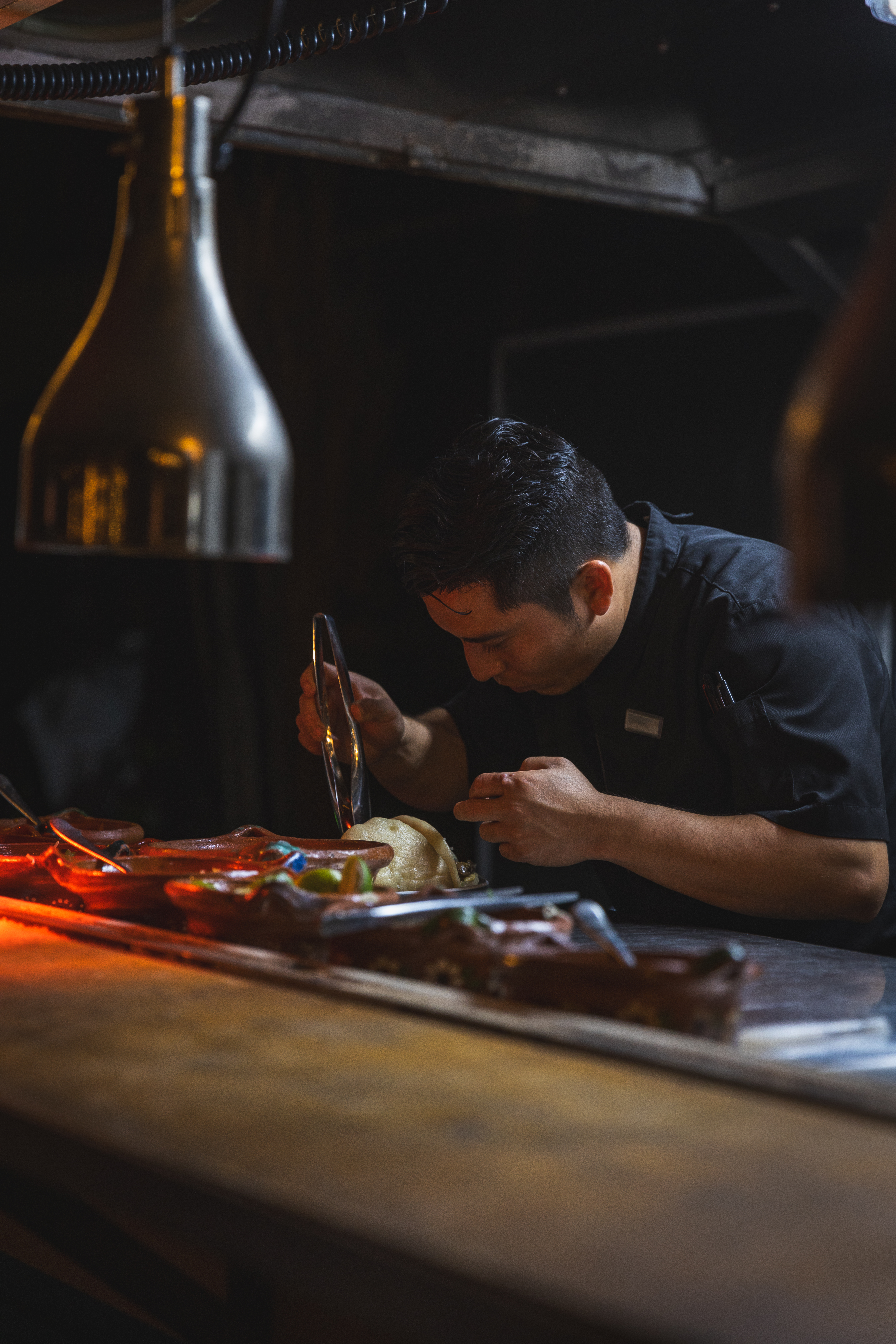 Man, meticulously assembling food