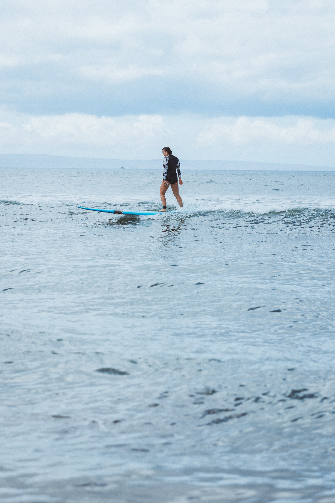 Emily Mall surfing in Maui