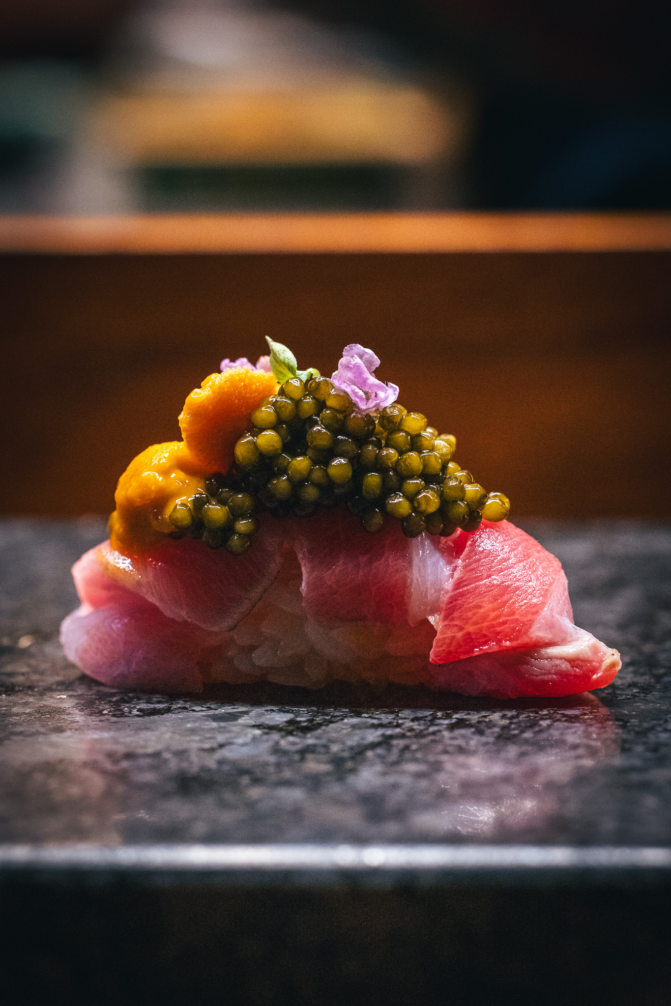 Fatty-tuna belly nigiri with caviar, uni, and edible flowers